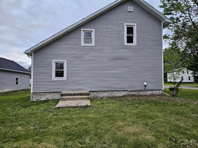 17045 Mill St, Hudson, MI 49247 - view of home's exterior with a yard