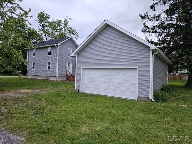 17045 Mill St, Hudson, MI 49247 - view of side of home with a lawn and a garage