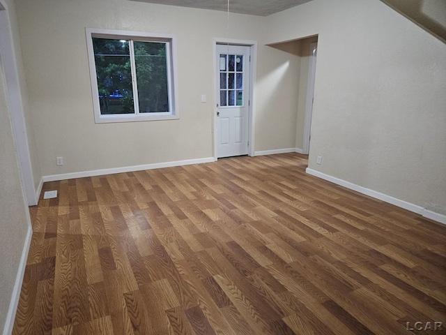 17045 Mill St, Hudson, MI 49247 - spare room featuring wood finished floors and baseboards