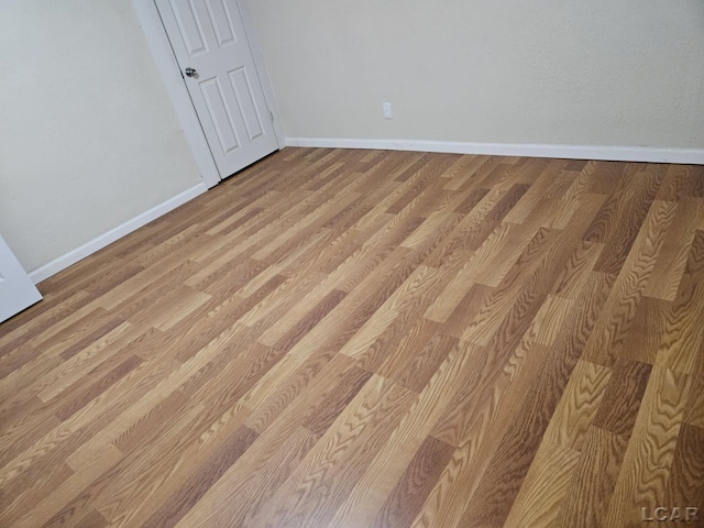 17045 Mill St, Hudson, MI 49247 - unfurnished bedroom featuring baseboards and light wood-style flooring