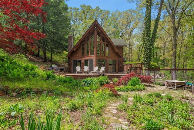 5765 Wildwood Dr, Bridgman, MI 49106 - rear view of house with a deck and a chimney