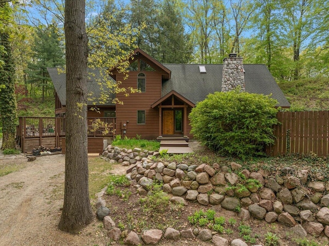 5765 Wildwood Dr, Bridgman, MI 49106 - rustic home with roof with shingles, a deck, and a chimney