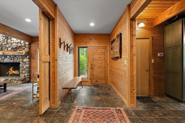 5765 Wildwood Dr, Bridgman, MI 49106 - entryway with wooden walls, stone finish flooring, recessed lighting, and a fireplace