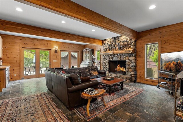 5765 Wildwood Dr, Bridgman, MI 49106 - living room with stone tile floors, plenty of natural light, wood walls, recessed lighting, and a fireplace
