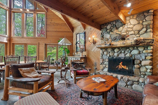 5765 Wildwood Dr, Bridgman, MI 49106 - living area featuring wood walls, healthy amount of natural light, high vaulted ceiling, wood ceiling with exposed beams, and a fireplace