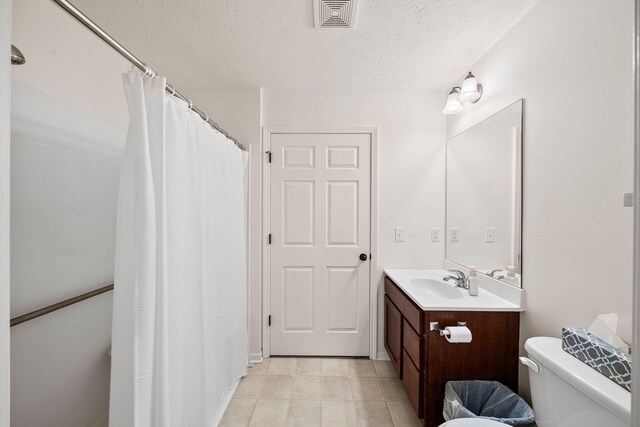 64711 Shorewood Ln, Cassopolis, MI 49031 - bathroom with toilet, a textured ceiling, vanity, tile patterned floors, and a shower with curtain