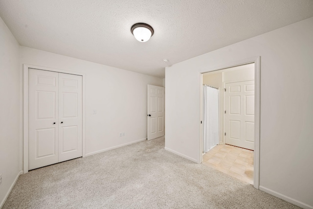 64711 Shorewood Ln, Cassopolis, MI 49031 - unfurnished bedroom with light colored carpet, baseboards, a closet, and a textured ceiling