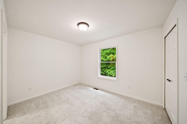 64711 Shorewood Ln, Cassopolis, MI 49031 - unfurnished bedroom featuring carpet flooring, a textured ceiling, baseboards, and a closet