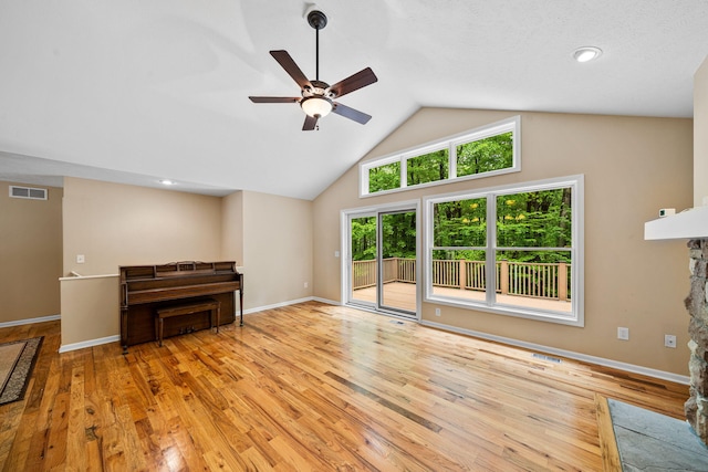 64711 Shorewood Ln, Cassopolis, MI 49031 - unfurnished living room featuring ceiling fan, light wood finished floors, baseboards, high vaulted ceiling, and a fireplace