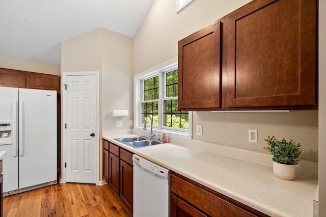 64711 Shorewood Ln, Cassopolis, MI 49031 - kitchen featuring white appliances, a sink, light wood-type flooring, light countertops, and vaulted ceiling