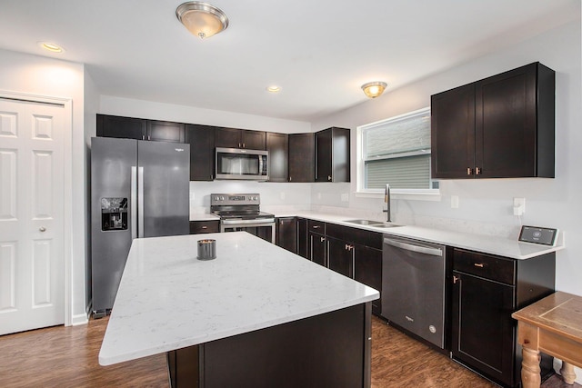 7131 Creekway Ct, Ypsilanti, MI 48197 - kitchen with appliances with stainless steel finishes, a sink, a center island, dark wood-type flooring, and recessed lighting
