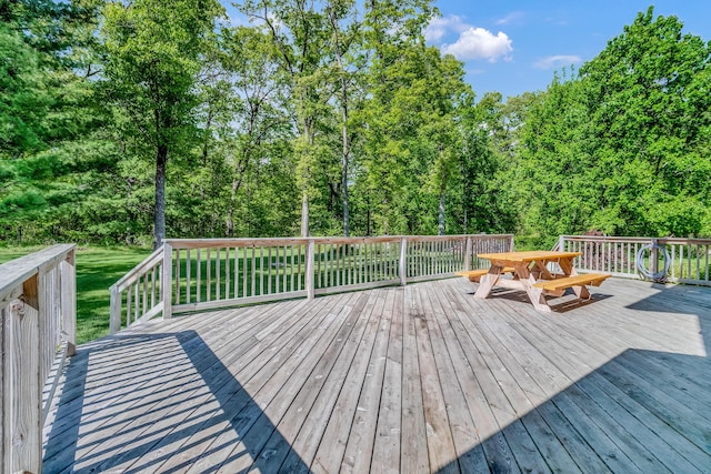 6248 Black Forest Trl, Muskegon, MI 49442 - wooden terrace featuring outdoor dining area and a lawn