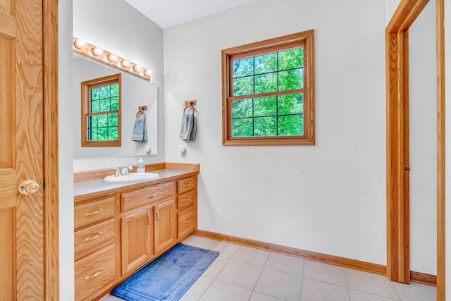 6248 Black Forest Trl, Muskegon, MI 49442 - bathroom featuring plenty of natural light, vanity, baseboards, and tile patterned flooring