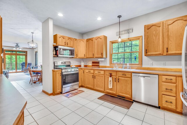 6248 Black Forest Trl, Muskegon, MI 49442 - kitchen with stainless steel appliances, a sink, ceiling fan, decorative light fixtures, and plenty of natural light