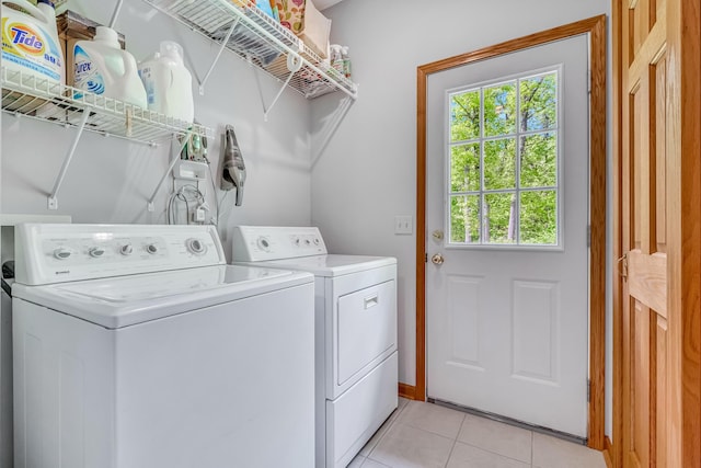 6248 Black Forest Trl, Muskegon, MI 49442 - laundry area with washing machine and dryer, healthy amount of natural light, and light tile patterned floors