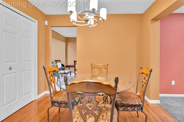 19298 Mitchell St, Rockwood, MI 48173 - dining room with a chandelier, wood finished floors, and baseboards