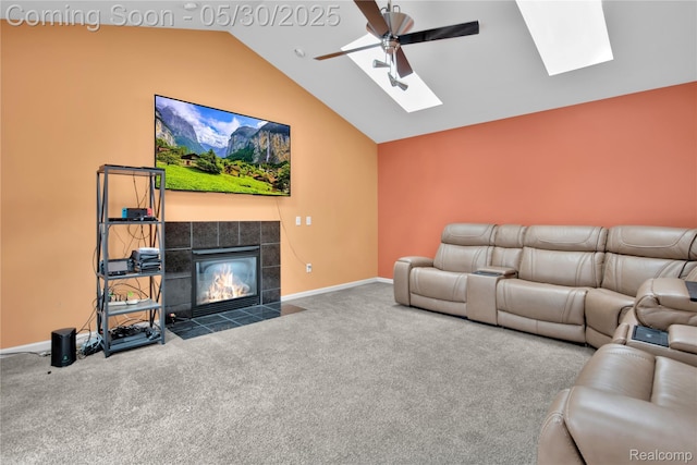 19298 Mitchell St, Rockwood, MI 48173 - carpeted living area featuring a skylight, a ceiling fan, vaulted ceiling, a tiled fireplace, and baseboards