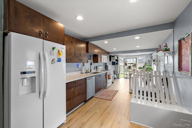 1942 E Troy St, Ferndale, MI 48220 - kitchen with stainless steel appliances, a sink, light wood-type flooring, dark brown cabinets, and light countertops