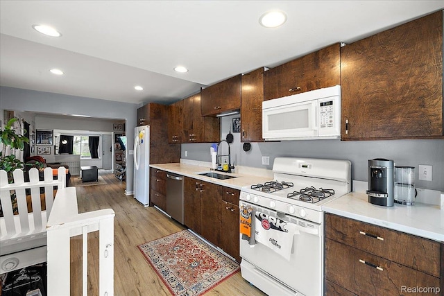1942 E Troy St, Ferndale, MI 48220 - kitchen with white appliances, a sink, light wood finished floors, dark brown cabinets, and light countertops