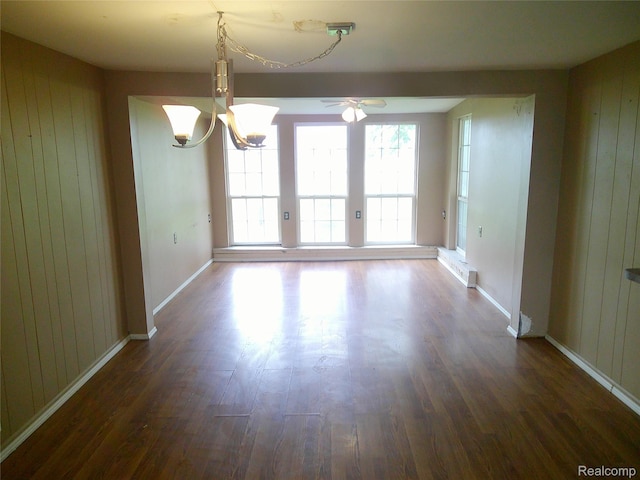 4755 E Washington Rd, Saginaw, MI 48601 - unfurnished dining area featuring ceiling fan, dark wood-type flooring, baseboards, wood walls, and a chandelier