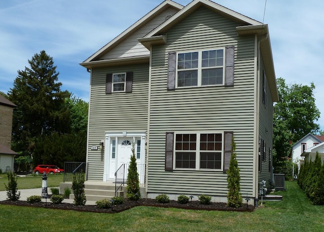 317 Monroe St, South Haven, MI 49090 - rear view of house with central AC unit and a lawn
