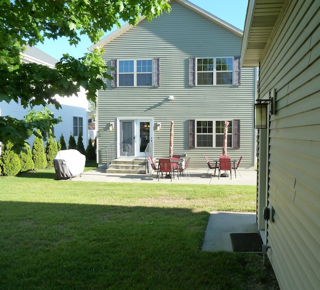 317 Monroe St, South Haven, MI 49090 - rear view of house featuring a lawn and a patio