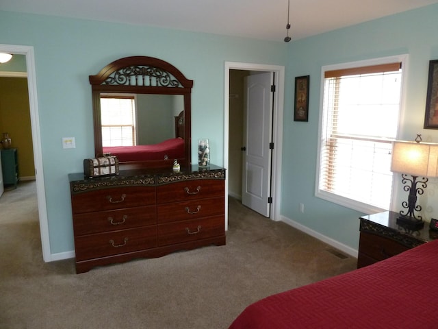 317 Monroe St, South Haven, MI 49090 - bedroom featuring light carpet, multiple windows, and baseboards