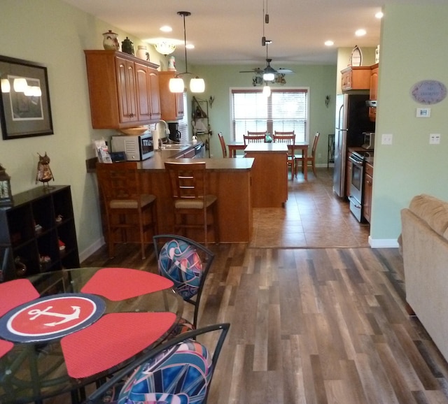 317 Monroe St, South Haven, MI 49090 - kitchen with stainless steel electric range oven, a peninsula, ceiling fan, recessed lighting, and pendant lighting