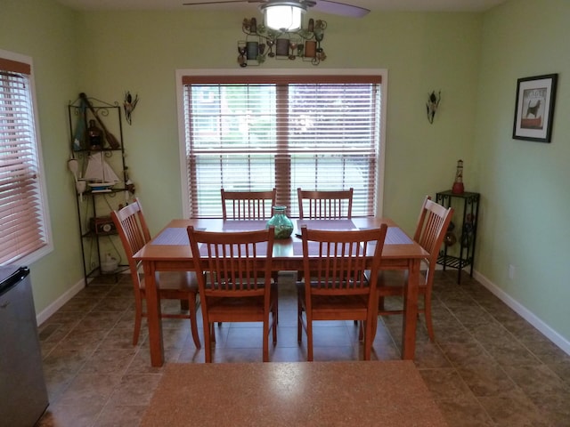 317 Monroe St, South Haven, MI 49090 - tiled dining space featuring a ceiling fan and baseboards