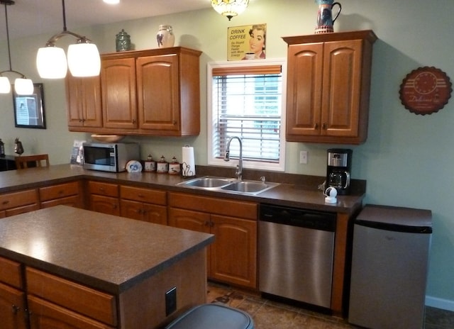 317 Monroe St, South Haven, MI 49090 - kitchen featuring appliances with stainless steel finishes, a sink, dark countertops, brown cabinetry, and a peninsula