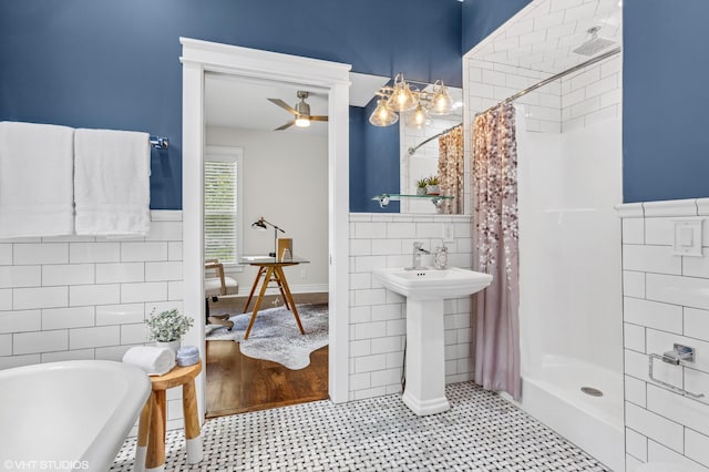 1310 Harrison Ave, Saint Joseph, MI 49085 - full bathroom featuring tile walls, a shower with curtain, a bath, ceiling fan, and tile patterned floors