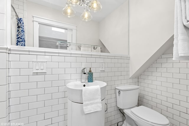 1310 Harrison Ave, Saint Joseph, MI 49085 - full bathroom featuring toilet, tile walls, a wainscoted wall, and a shower with curtain