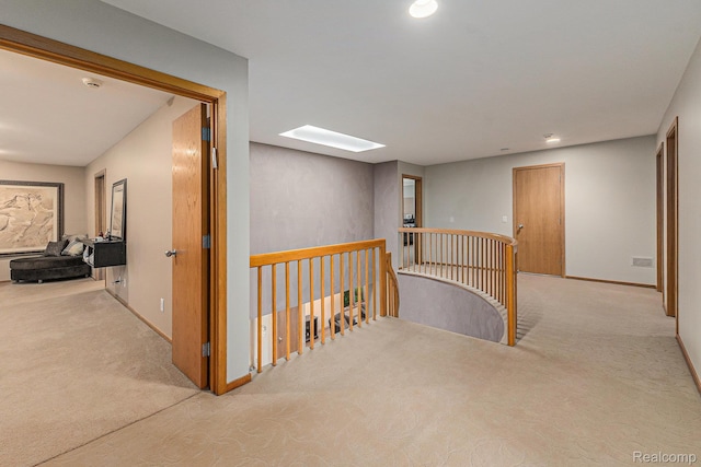 3870 Glen Falls Dr, Bloomfield Hills, MI 48302 - hallway with an upstairs landing, carpet, a skylight, baseboards, and recessed lighting