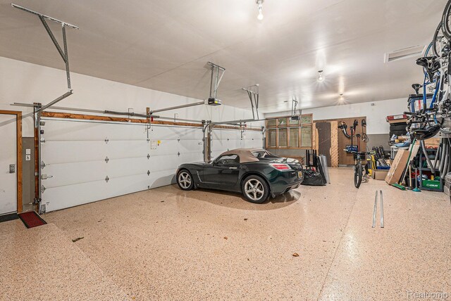 3870 Glen Falls Dr, Bloomfield Hills, MI 48302 - garage featuring a garage door opener