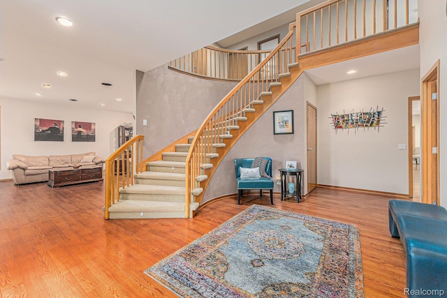 3870 Glen Falls Dr, Bloomfield Hills, MI 48302 - staircase featuring wood finished floors, recessed lighting, baseboards, and a high ceiling