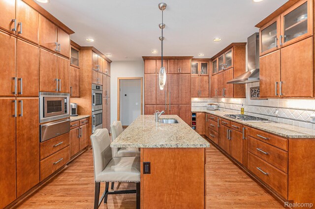 3870 Glen Falls Dr, Bloomfield Hills, MI 48302 - kitchen with a warming drawer, wall chimney range hood, stainless steel appliances, light wood-style floors, and recessed lighting