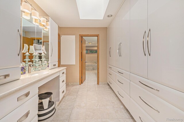3870 Glen Falls Dr, Bloomfield Hills, MI 48302 - bathroom featuring vanity, a skylight, and tile patterned floors