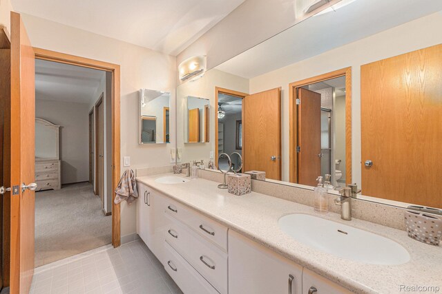 3870 Glen Falls Dr, Bloomfield Hills, MI 48302 - full bath with double vanity, toilet, and tile patterned floors