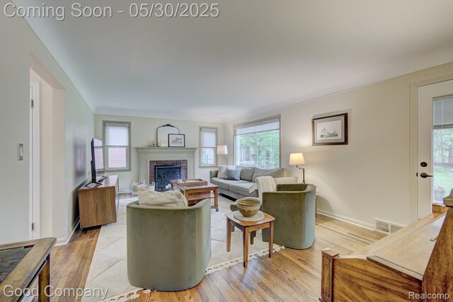 1012 W 12 Mile Rd, Royal Oak, MI 48073 - living area with a brick fireplace, healthy amount of natural light, and light wood-style floors