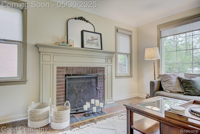 1012 W 12 Mile Rd, Royal Oak, MI 48073 - living room featuring baseboards, wood finished floors, and a brick fireplace