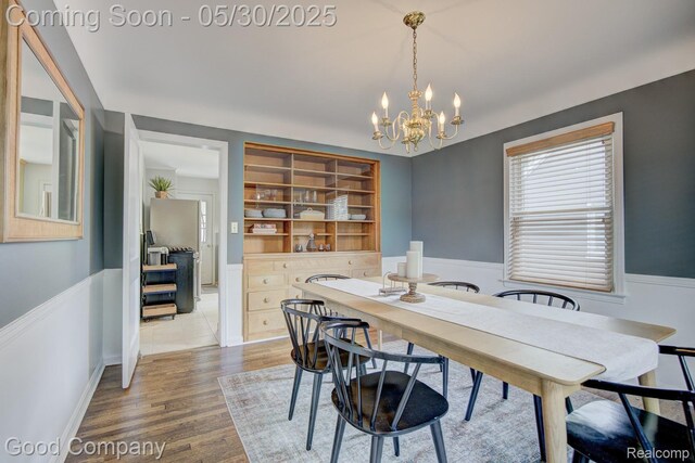 1012 W 12 Mile Rd, Royal Oak, MI 48073 - dining area with wood finished floors, a chandelier, and a wainscoted wall