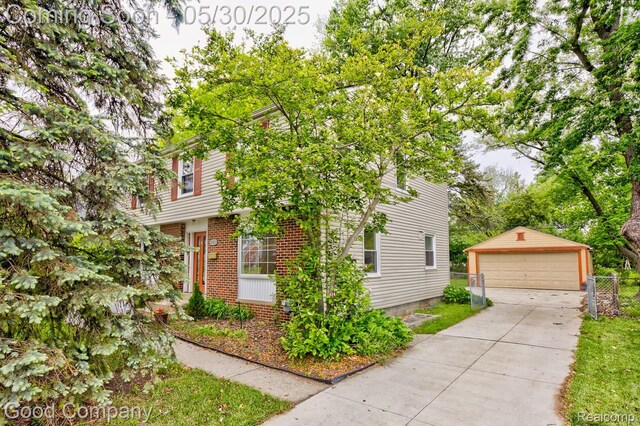 1012 W 12 Mile Rd, Royal Oak, MI 48073 - view of front facade featuring a garage, an outdoor structure, and brick siding