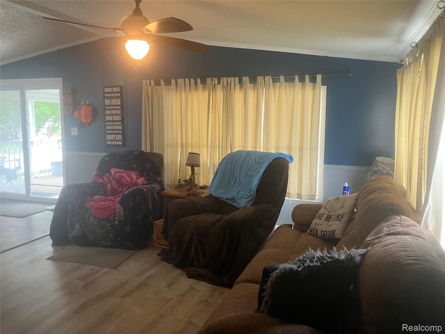 402 Katie Ln, Morrice, MI 48857 - living room featuring lofted ceiling, ornamental molding, wainscoting, wood finished floors, and a textured ceiling
