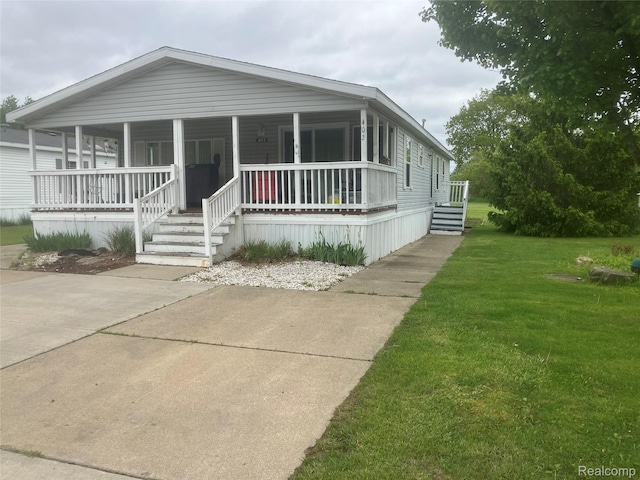 402 Katie Ln, Morrice, MI 48857 - manufactured / mobile home featuring a front lawn and covered porch