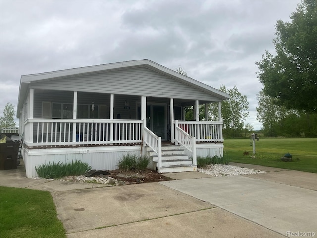 402 Katie Ln, Morrice, MI 48857 - manufactured / mobile home featuring covered porch