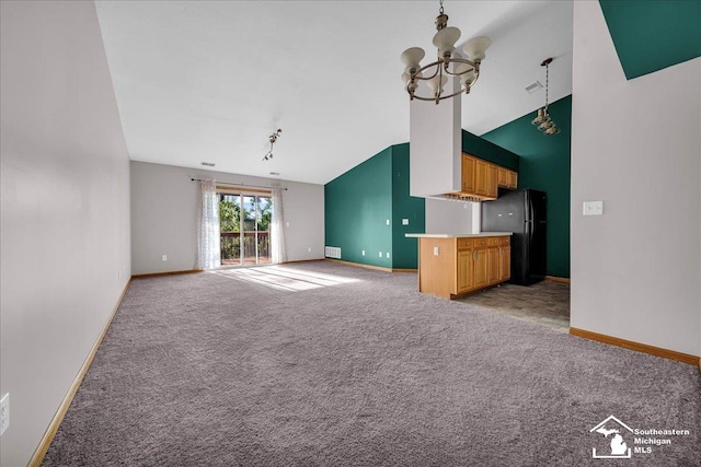 15795 Lakeside Dr, Southgate, MI 48195 - unfurnished living room with lofted ceiling, a chandelier, light carpet, and baseboards
