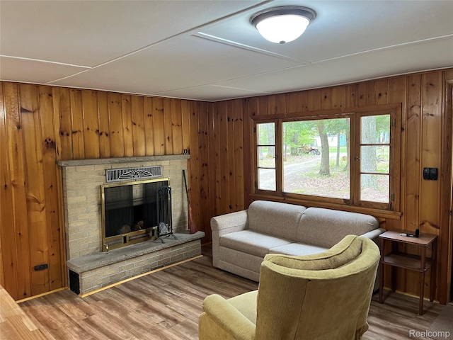 478 Karcher Rd, Rose City, MI 48654 - living room with wood finished floors, wooden walls, and a fireplace