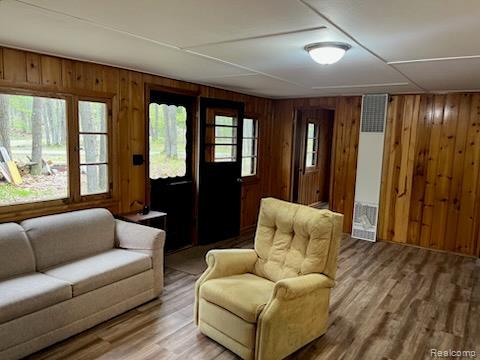 478 Karcher Rd, Rose City, MI 48654 - living area with a heating unit, wooden walls, and wood finished floors