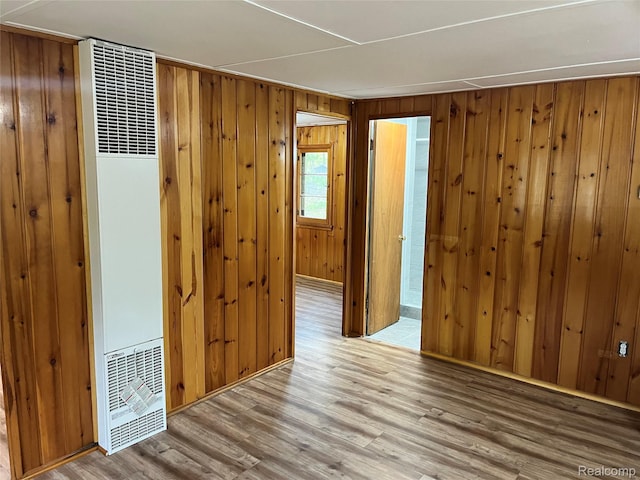478 Karcher Rd, Rose City, MI 48654 - spare room featuring a heating unit, wood finished floors, and wood walls