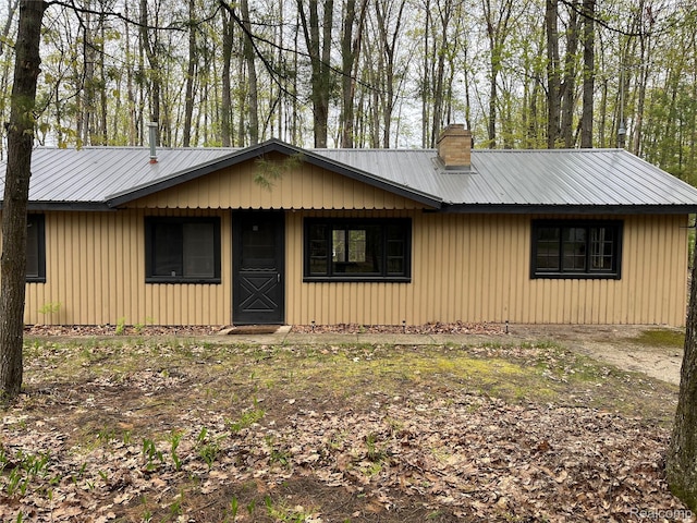478 Karcher Rd, Rose City, MI 48654 - view of front facade featuring a chimney and metal roof